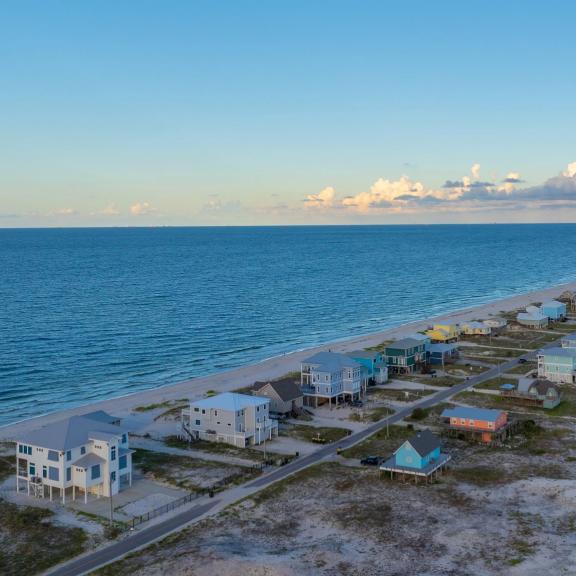 Aerial view of beach houses along the water in Fort Morgan